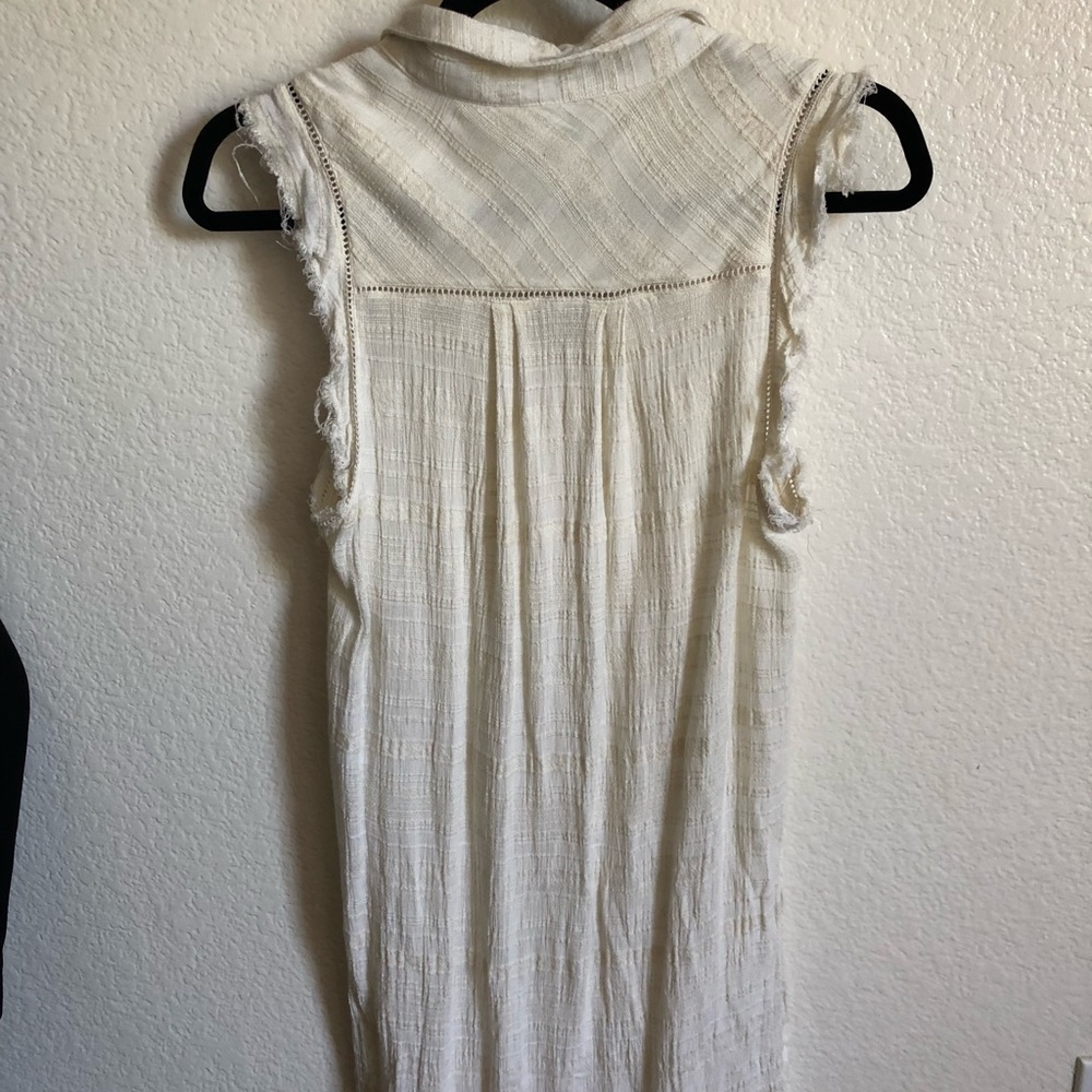 Long white sleeveless button down blouse